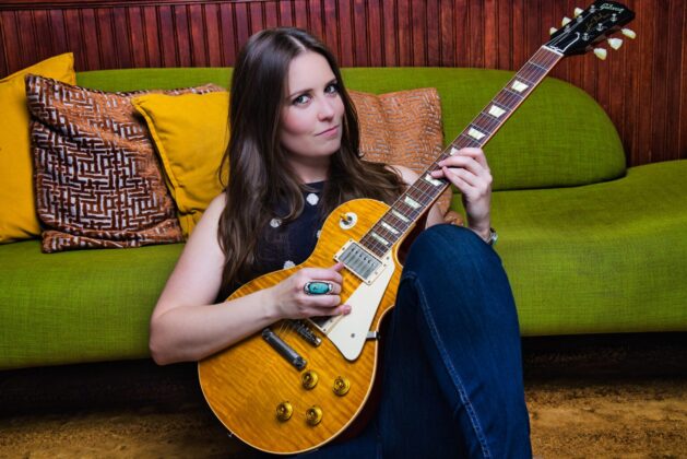 Angela Petrilli featured in the July 2023 Guitar Girl Magazine Calendar with a Gibson electric guitar