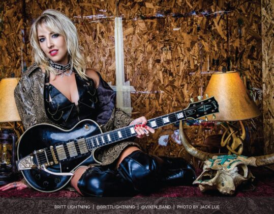 Britt Lightning featured in the September 2023 Guitar Girl Magazine Calendar holding a Gibson electric guitar
