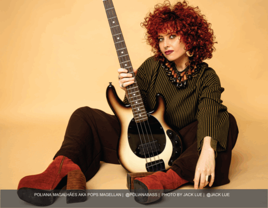 Pops Magellan featured in the September 2025 Guitar Girl Magazine calendar holding a bass guitar