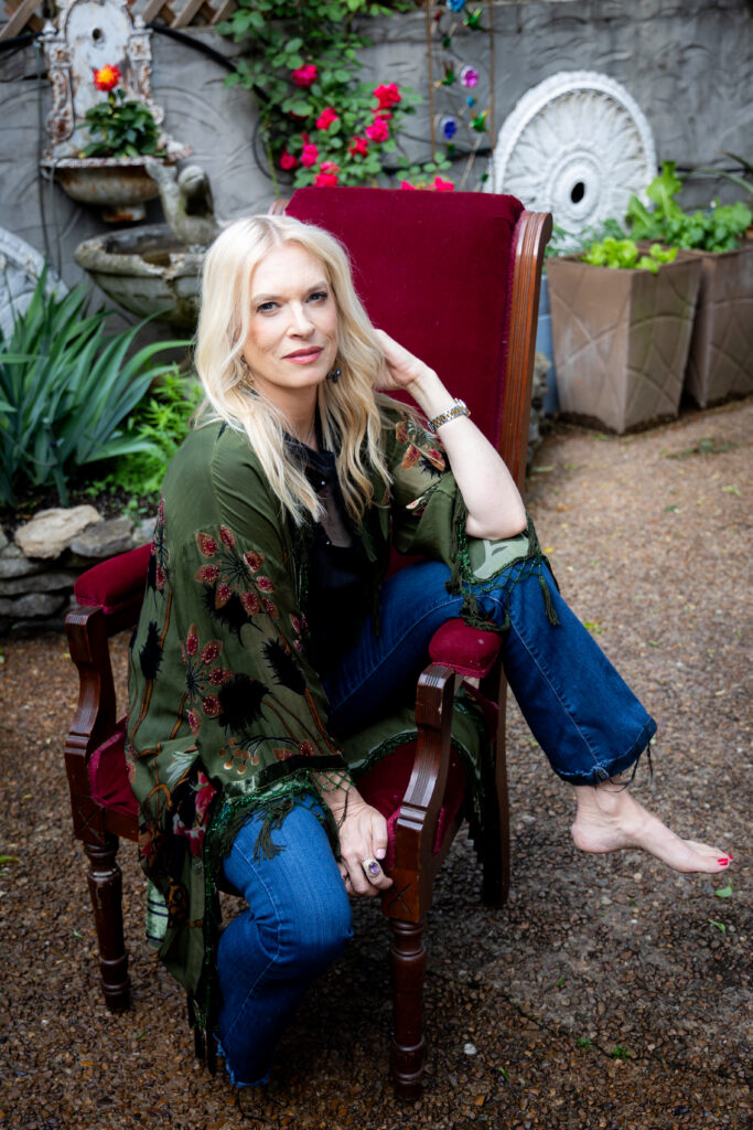 blonde woman sitting in chair in outdoor setting