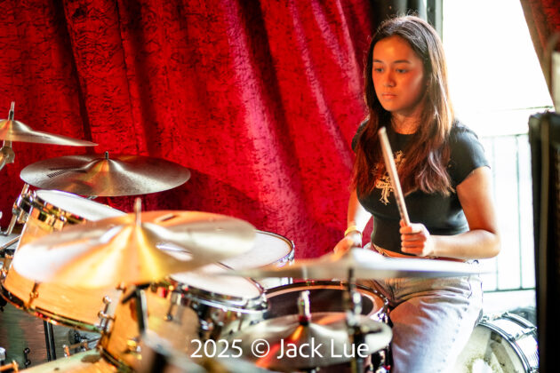 girl playing drums onstage