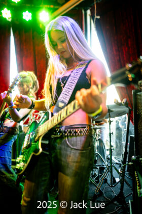 girl playing guitar onstage