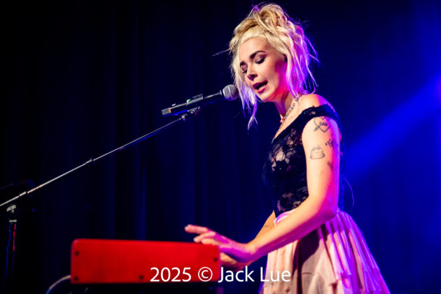 girl playing keyboard onstage
