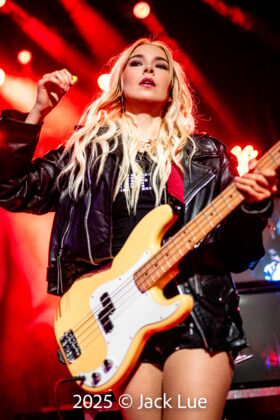 girl playing guitar onstage