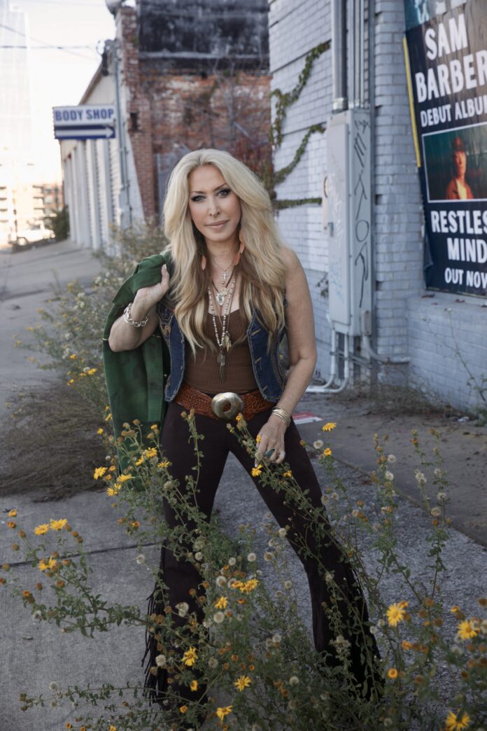 blonde country music singer-songwriter standing