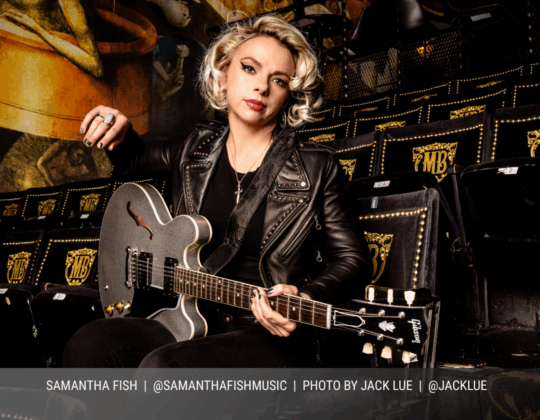 March page of the 2026 Guitar Girl Magazine calendar featuring guitarist Samantha Fish seated with a Gibson electric guitar in at The Fonda Theater..