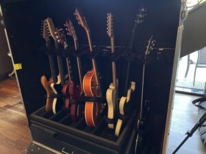 A collection of electric and acoustic guitars in a rolling guitar rack at Nashville’s Blackbird Studio.